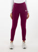Women's Mavis Jogger in Dark Raspberry, front model view featuring a deep berry waffle-knit jogger with elasticated waistband, side pocket with Straight Down logo patch, and ankle vent detail paired with a white long sleeve top and white athletic shoes