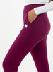 Women's Mavis Jogger in Dark Raspberry, close-up side model view featuring a deep berry waffle-knit jogger with elasticated waistband, side pocket with tonal Straight Down logo patch, and front seam detail