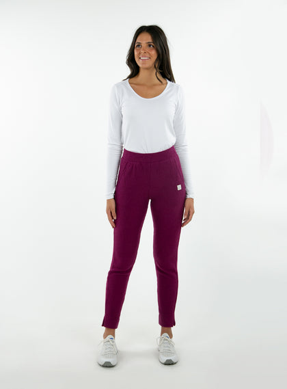 Women's Mavis Jogger in Dark Raspberry, full length model view featuring a deep berry waffle-knit jogger with elasticated waistband, Straight Down logo patch, and tapered leg with ankle vent detail paired with a white long sleeve top and white athletic shoes