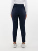 Women's Mavis Jogger in Ink, back model view featuring a navy waffle-knit jogger with elasticated waistband, clean back panel, and tapered leg with cuffed hem paired with a white long sleeve top and white athletic shoes