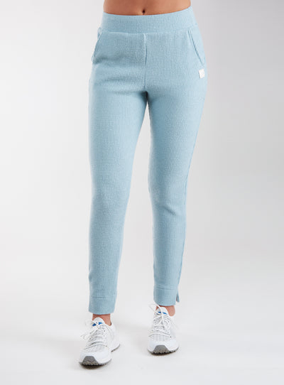 Women's Mavis Jogger in Mineral, front model view featuring a soft aqua waffle-knit jogger with elasticated waistband, side pocket with Straight Down logo patch, and ankle vent detail paired with white athletic shoes