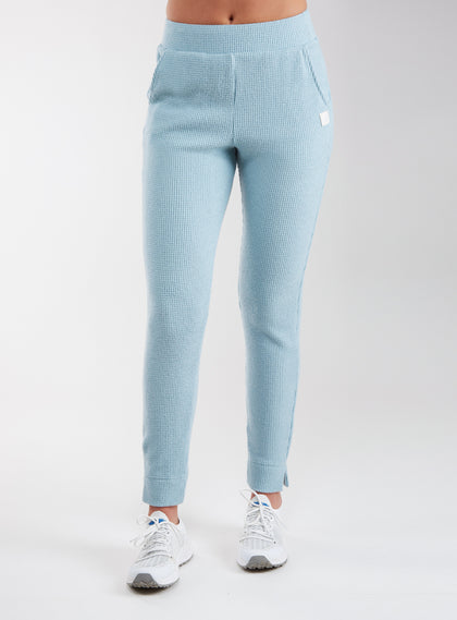 Women's Mavis Jogger in Mineral, front model view featuring a soft aqua waffle-knit jogger with elasticated waistband, side pocket with Straight Down logo patch, and ankle vent detail paired with white athletic shoes