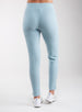 Women's Mavis Jogger in Mineral, back model view featuring a soft aqua waffle-knit jogger with elasticated waistband, clean back panel, and tapered leg with cuffed hem paired with white athletic shoes