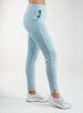 Women's Mavis Jogger in Mineral, side model view featuring a soft aqua waffle-knit jogger with elasticated waistband, side pocket, front seam detail, and ankle vent detail