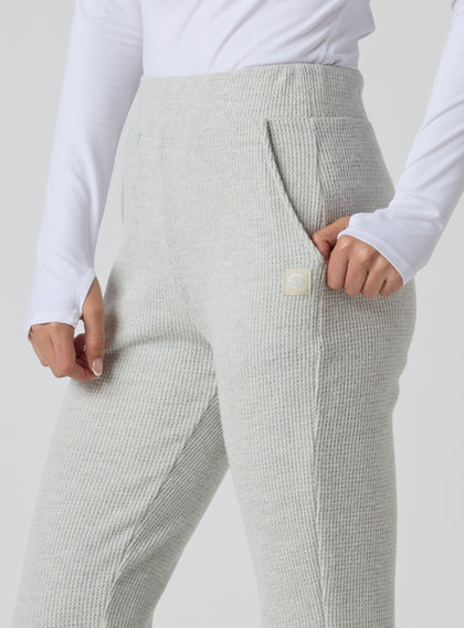 Women's Mavis Jogger in New Heather, close-up model view featuring a heather grey waffle-knit jogger with elasticated waistband, front seam detail, side pocket, and tonal Straight Down logo patch