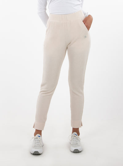 Women's Mavis Jogger in Oyster, front model view featuring an off-white waffle-knit jogger with elasticated waistband, side pocket with tonal Straight Down logo, and ankle vent detail paired with a white long sleeve top and white athletic shoes