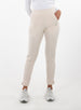 Women's Mavis Jogger in Oyster, front model view featuring an off-white waffle-knit jogger with elasticated waistband, side pocket with tonal Straight Down logo, and ankle vent detail paired with a white long sleeve top and white athletic shoes