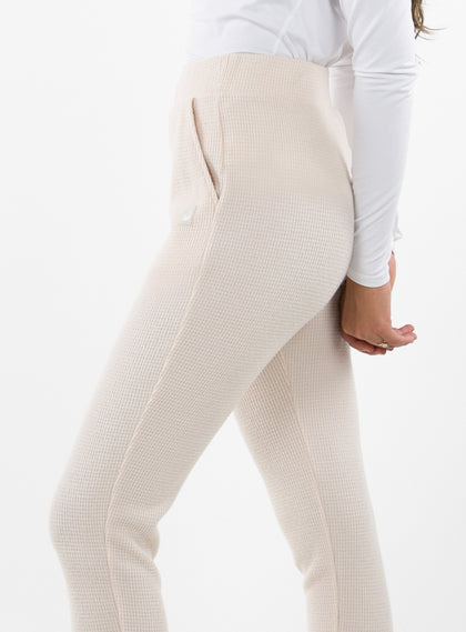 Women's Mavis Jogger in Oyster, close-up side model view featuring an off-white waffle-knit jogger with elasticated waistband, side pocket with tonal Straight Down logo patch, and front seam detail