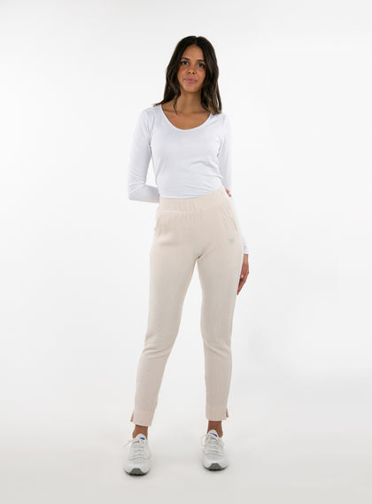 Women's Mavis Jogger in Oyster, full length model view featuring an off-white waffle-knit jogger with elasticated waistband, tonal Straight Down logo, and tapered leg with ankle vent detail paired with a white long sleeve top and white athletic shoes