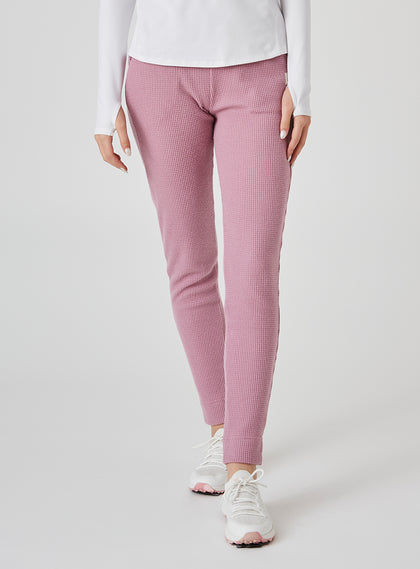 Women's Mavis Jogger in Peonie, front model view featuring a dusty rose waffle-knit jogger with elasticated waistband, side pocket, and ankle vent detail paired with a white long sleeve top and white athletic shoes
