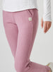 Women's Mavis Jogger in Peonie, close-up model view featuring a dusty rose waffle-knit jogger with elasticated waistband, front seam detail, side pocket, and tonal Straight Down logo patch