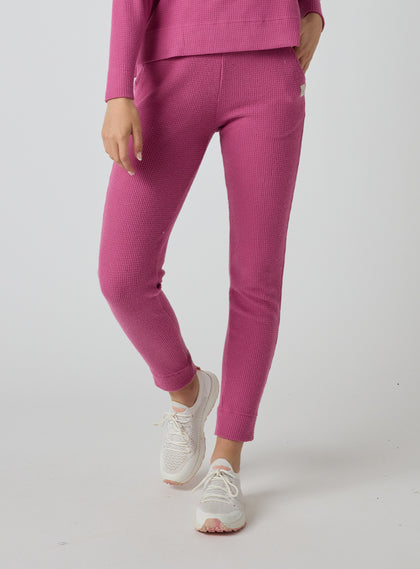 Women's Mavis Jogger in Rosewine, front model view featuring a bold rose waffle-knit jogger with elasticated waistband, side pocket with Straight Down logo patch, and cuffed hem paired with a matching waffle-knit top and white athletic shoes