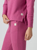 Women's Mavis Jogger in Rosewine, close-up model view featuring a bold rose waffle-knit jogger with elasticated waistband, angled side pocket, and tonal Straight Down logo patch alongside a matching waffle-knit top with Straight Down logo patch