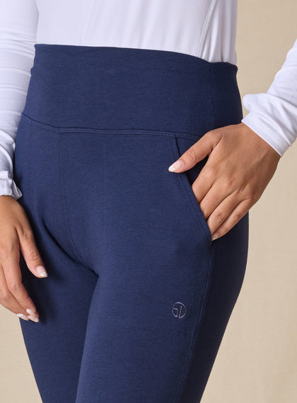 Women's Topia Jogger in New Indigo, close-up model view featuring a navy smooth-knit jogger with wide elasticated waistband, angled side pocket, and tonal Straight Down logo embroidery