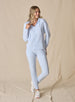 Women's Topia Jogger in Powder, full length model view featuring a soft blue smooth-knit jogger paired with a matching Mesa Hooded Jacket and white athletic shoes
