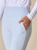 Women's Topia Jogger in Powder, close-up model view featuring a soft blue smooth-knit jogger with wide elasticated waistband, angled side pocket, and tonal Straight Down logo embroidery