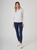 Sedona Legging in New Indigo, full body on model front view featuring the solid navy high-waisted legging, styled with a white quarter-zip long sleeve top and white shoes