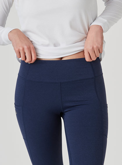 Sedona Legging in New Indigo, on model close-up front view highlighting the high waistband and side pocket details on the solid navy legging