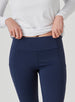 Sedona Legging in New Indigo, on model close-up front view highlighting the high waistband and side pocket details on the solid navy legging