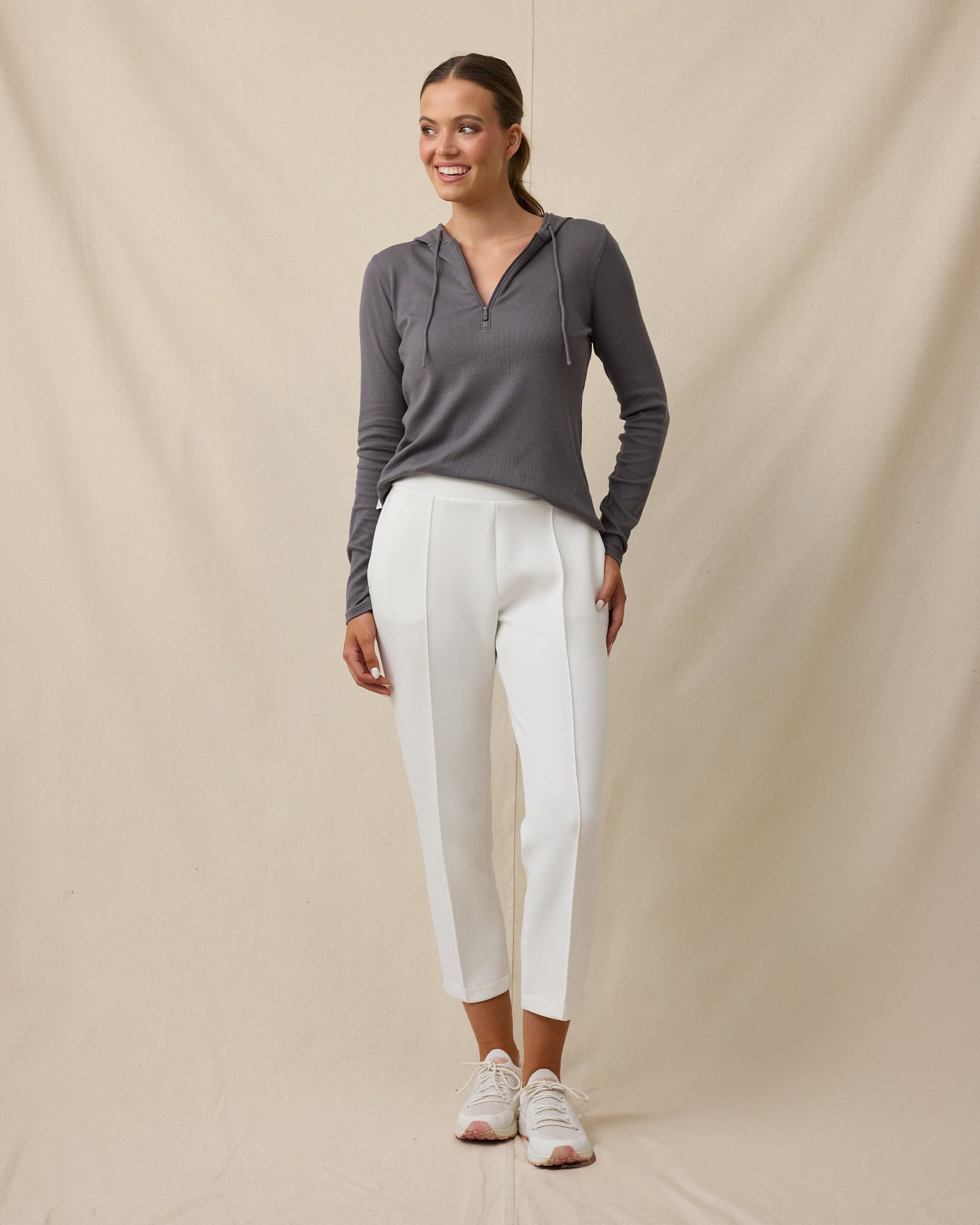 Model wearing the Straight Down Chelsea Pant in Coconut with a charcoal long sleeve hoodie