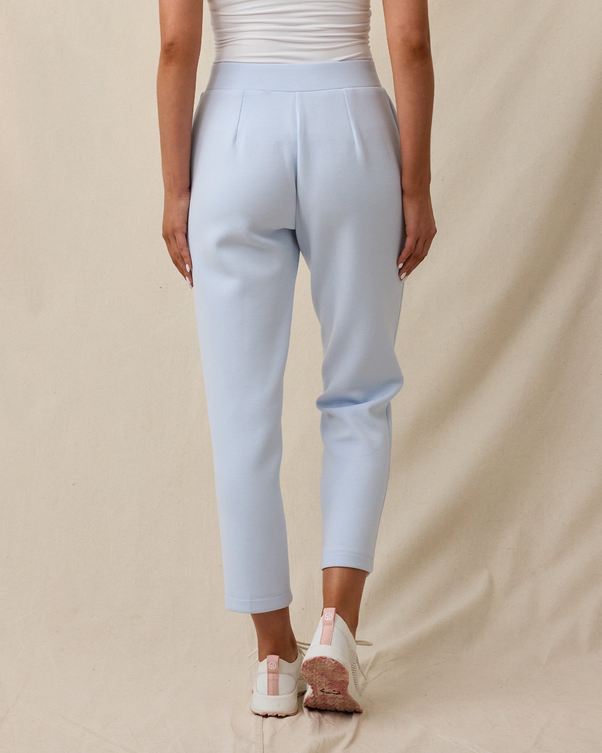 Back view of a woman wearing the Chelsea Pant in Lake, showing the clean tailored fit and cropped silhouette.