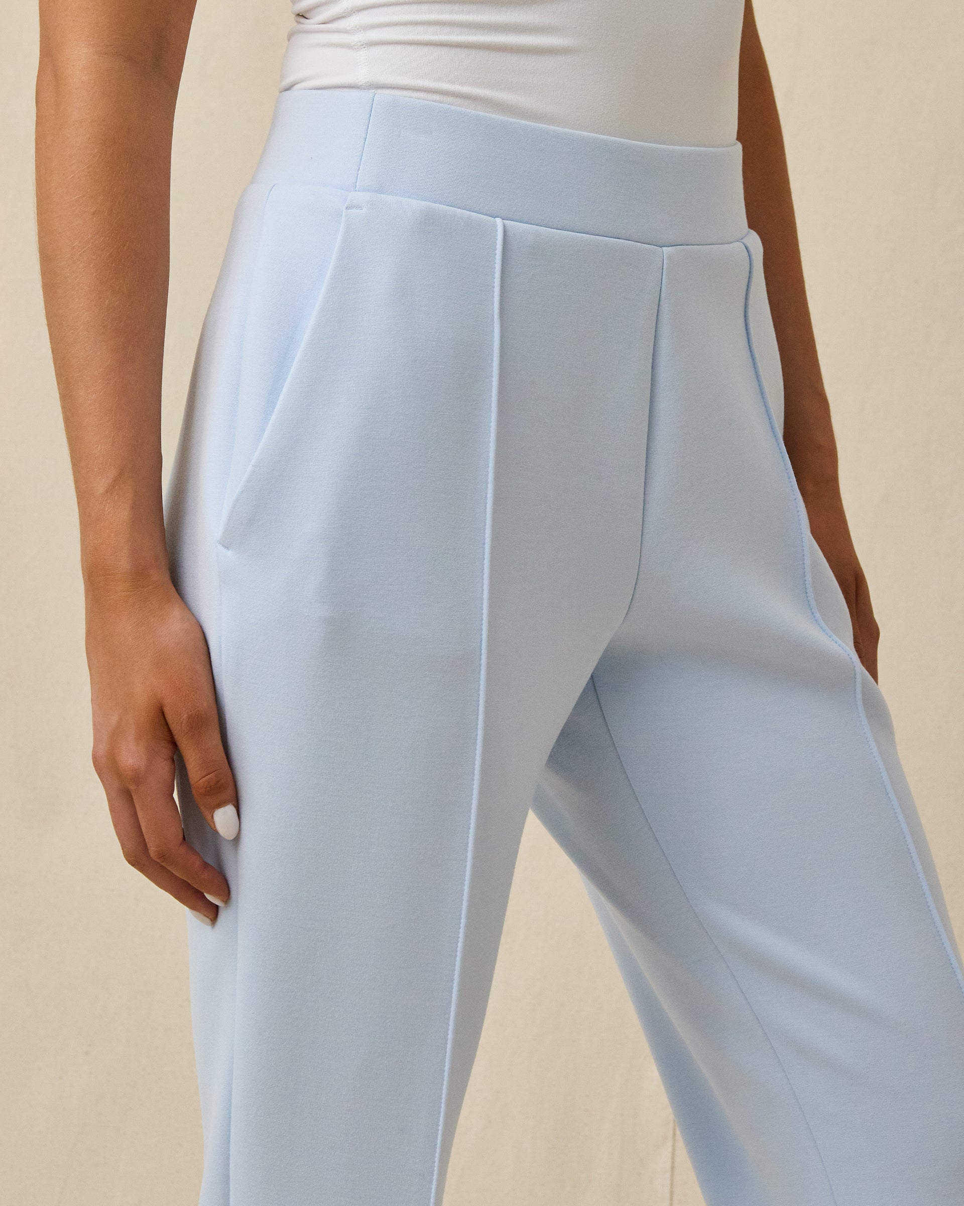 Close-up of the Chelsea Pant in Lake showing the wide waistband, front pleats, seam detailing, and side pocket.