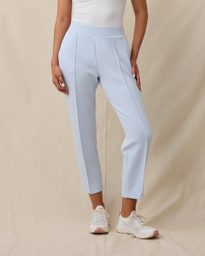 Woman wearing the Chelsea Pant in Lake, showing the high-rise fit, front pleats, and cropped length.