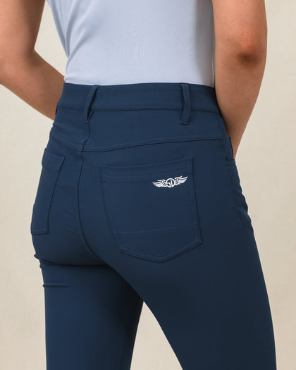 Stride Pant in New Indigo, close-up detail view on model featuring a back pocket with Straight Down logo embroidered in white