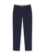 Women's Stride Pant in New Indigo, flat lay front view featuring solid navy fabric, front hip pockets, gold logo button closure, and a tapered leg