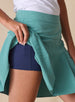 Women's Martina Skort in Sea Green, close-up detail view featuring the pleated skirt panel lifted to show the navy built-in shorts liner with side pocket