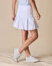 Women's Martina Skort in White, side view on model featuring a white pleated skort with a wide waistband and embroidered Straight Down logo paired with a light blue sleeveless top and white golf shoes