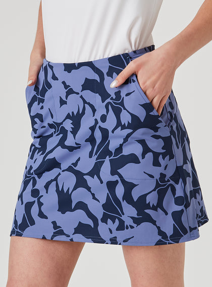 Women's Evie Skort in Blueberry, detail side model view highlighting the side pocket and bold navy and steel blue abstract floral print pattern of the skort
