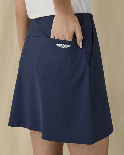 Evie Skort in New Indigo, close-up back view on model highlighting the back patch pocket and Straight Down logo detail