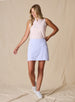 Women's Kyoto Skort in Hydrangea, on model front view full length styled with a pink sleeveless top and white golf shoes