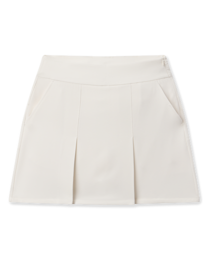 Korra Skort in Coconut with front pleats, side pockets, and a modern A-line silhouette