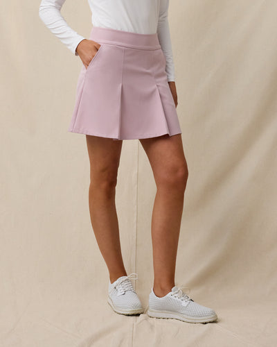 Model wearing the Korra Skort in Pink Dawn, showcasing the pleated front design