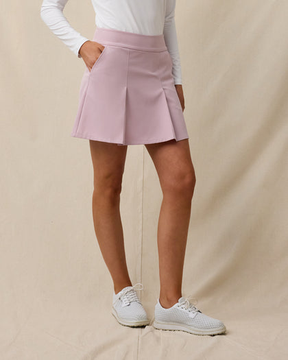 Model wearing the Korra Skort in Pink Dawn, showcasing the pleated front design