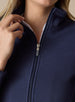 Swing Jacket in Indigo, close up detail view on model showing the silver zip pull, stand collar, and subtle horizontal texture in solid navy fabric