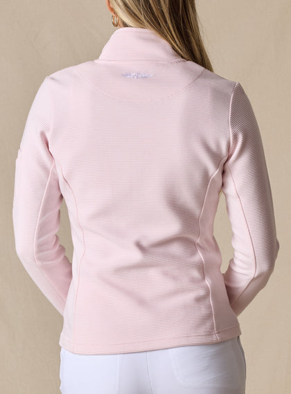 Swing Jacket in Light Pink, back view on model featuring solid light pink fabric with subtle horizontal texture and Straight Down logo embroidery at upper back styled with white pants