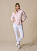 Swing Jacket in Light Pink, full length front view on model featuring solid light pink fabric with subtle horizontal texture and full zip closure styled with white pants and white shoes