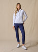Swing Jacket in White, full length front view on model featuring solid white fabric with subtle horizontal texture and full zip closure styled with navy pants and white shoes