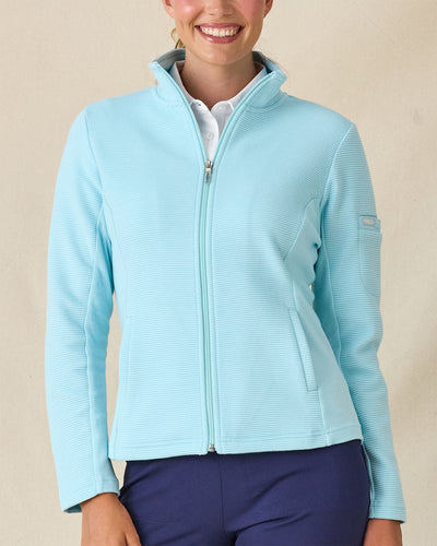 Swing Jacket in Gemstone, front view featuring a solid light blue ribbed texture full zip jacket with side pockets, paired with a white polo and navy pants