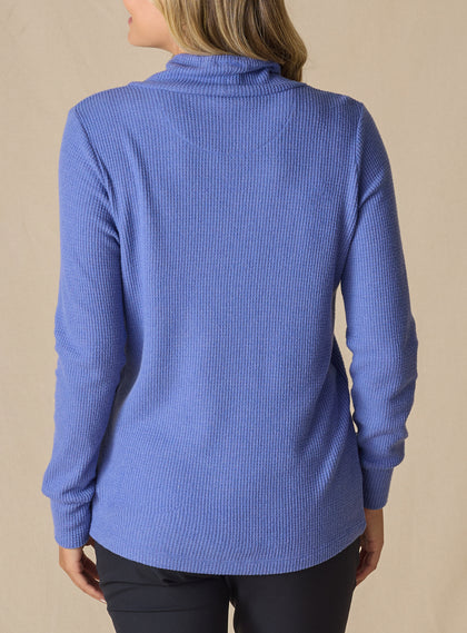 Women's Misty Top in Blueberry, back view on model featuring a solid blueberry waffle knit long sleeve top with cowl neck
