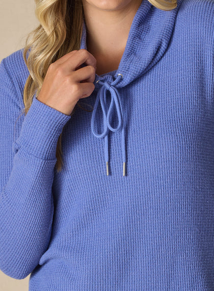  Women's Misty Top in Blueberry, detailed close-up view on model featuring a solid blueberry waffle knit long sleeve top with cowl neck and drawstring tie with silver aglets