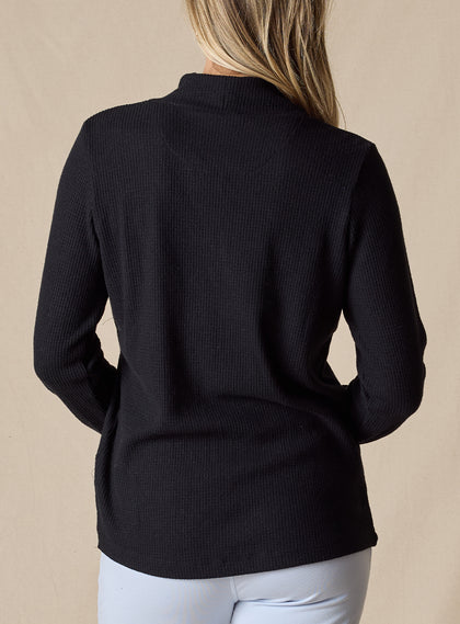 Women's Misty Top in Black, back view on model featuring a solid black waffle knit long sleeve top