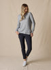 Women's Misty Top in Heather, full length front view on model featuring a heather gray waffle knit long sleeve top with cowl neck and drawstring tie, paired with black pants and white shoes