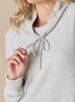 Women's Misty Top in New Heather, detailed close-up view on model featuring a heather gray waffle knit long sleeve top with cowl neck and drawstring tie