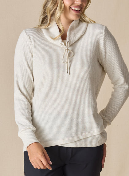 Women's Misty Top in Oatmeal, front close-up view on model featuring a cream waffle knit long sleeve top with cowl neck and drawstring tie