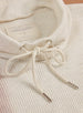 Women's Misty Top in Oatmeal, close detailed view of the cream waffle knit cowl neck and drawstring tie with silver aglets