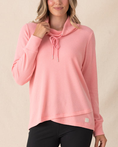 Misty Top in Spritz, front view featuring a solid pink waffle knit pullover with cowl neck and drawstring detail, paired with black pants